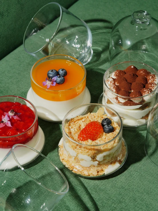 three dessert dishes have many different fruits on top