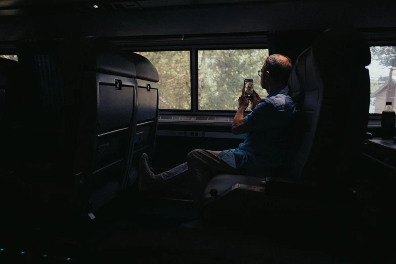 a person sitting at a table with a bottle