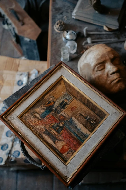 a pograph of a religious figure next to a wooden sculpture