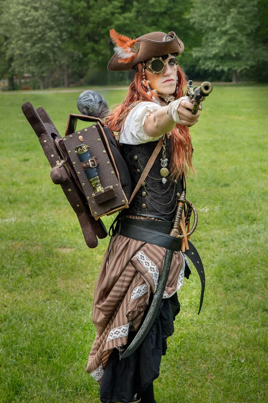 a lady with an elaborate outfit holding a gun