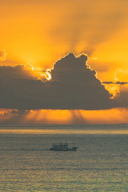 a boat floating on the water at sunset