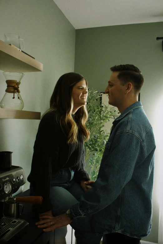 a woman is holding a man's waist while the man smiles