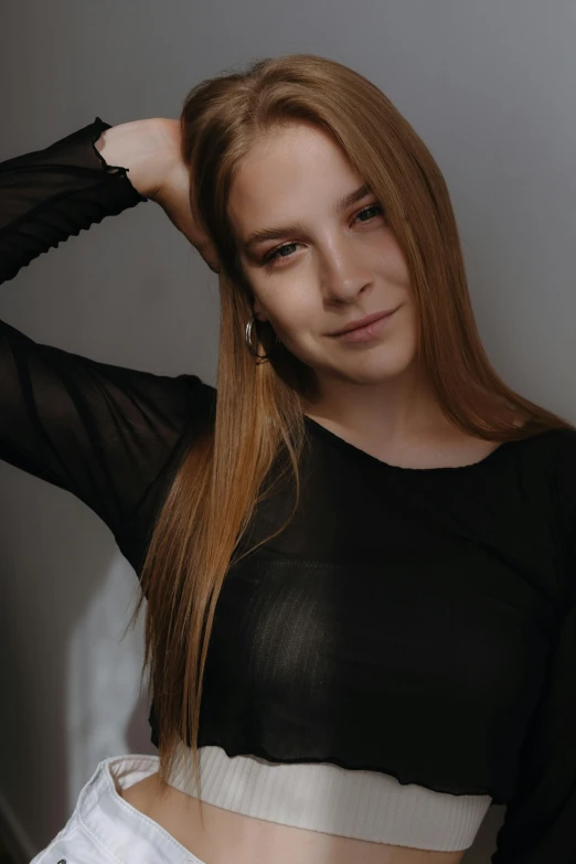 a girl with blond hair, wearing a black top