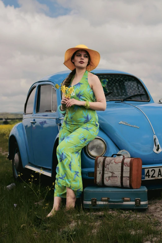 a woman is sitting on top of a car