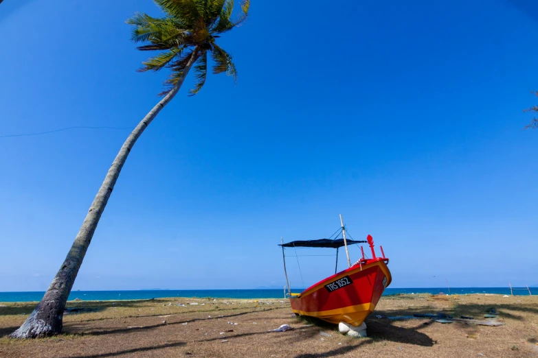 a boat sits on the shore near the ocean