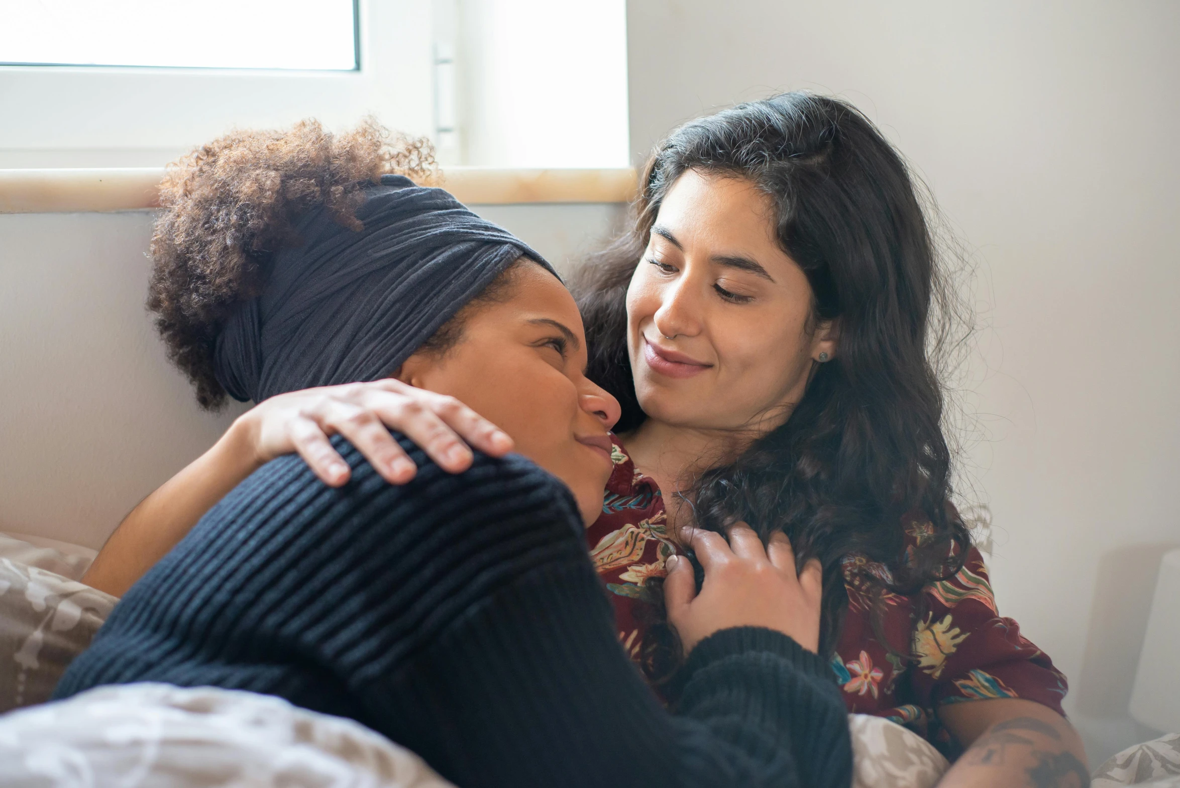 two women in their 40's hugging each other