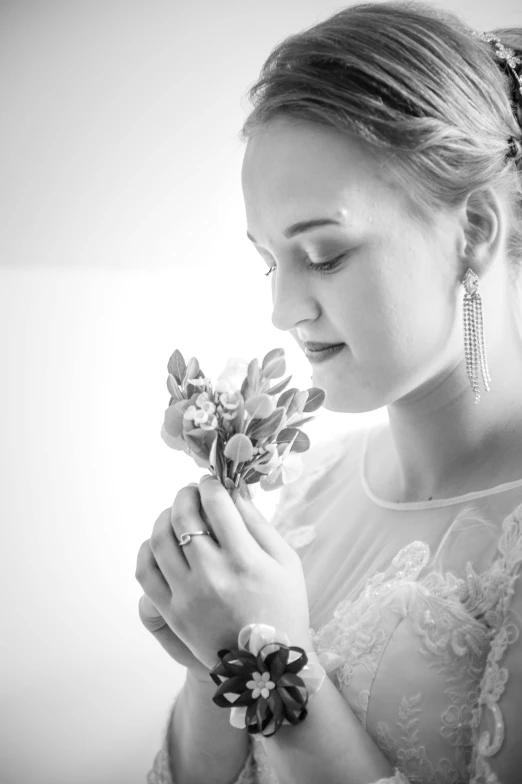 a woman is holding a flower in her hand