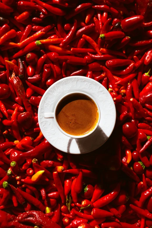 a bowl full of  chilis on top of a table