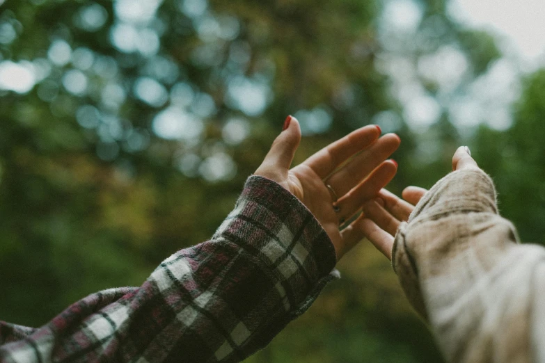 two people reaching out their hands towards each other