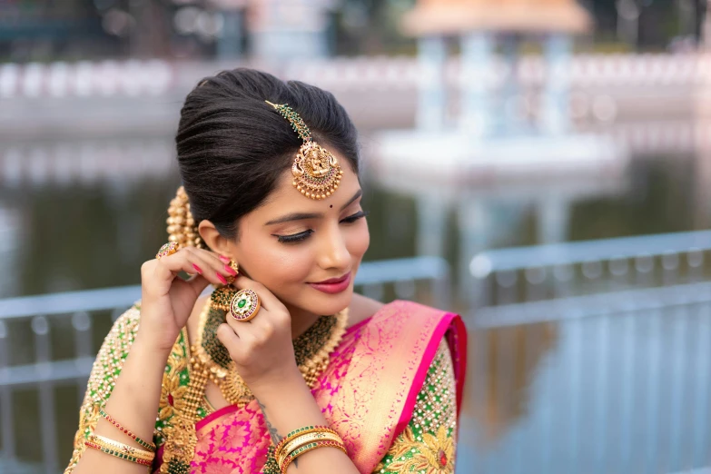 a woman dressed in an ethnic style holding a cellphone