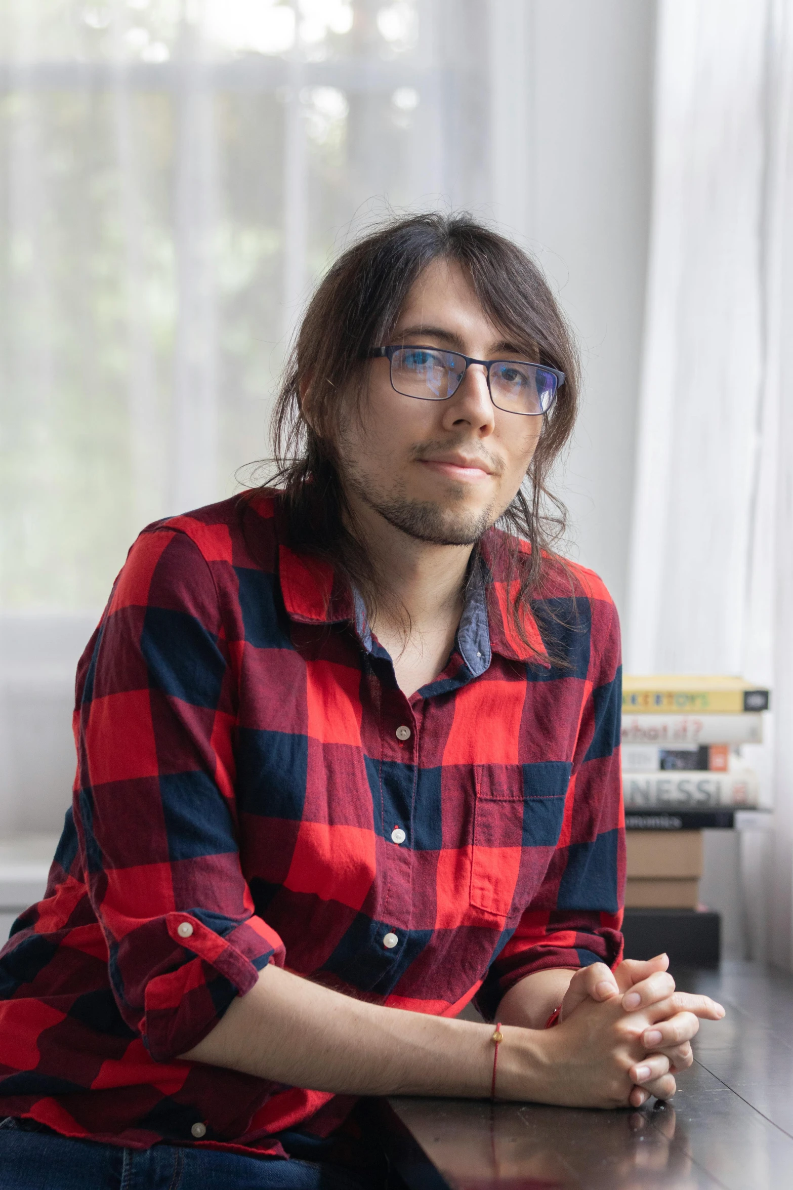 a man with glasses sitting on a desk