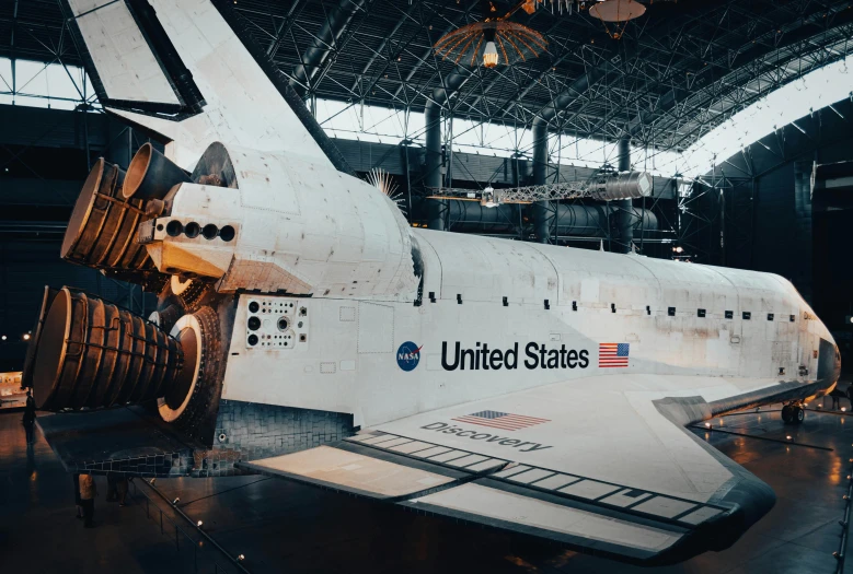 the space shuttle is displayed inside a large hangar