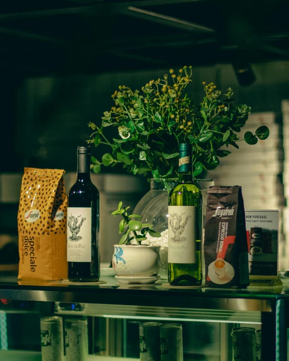 a table holding wine bottles and drinks in glasses