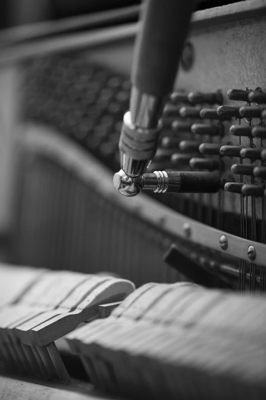 a black and white image of a machine with many strings