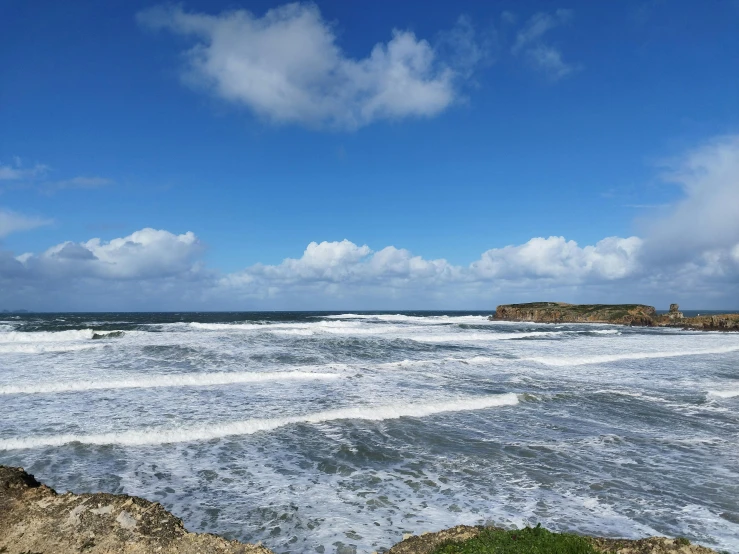 a very big choppy ocean near some rocks