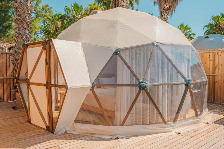 an outside cabana with sheer curtains on it