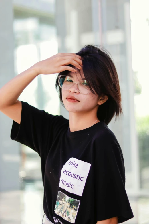 young asian woman with glasses looking up at the sky