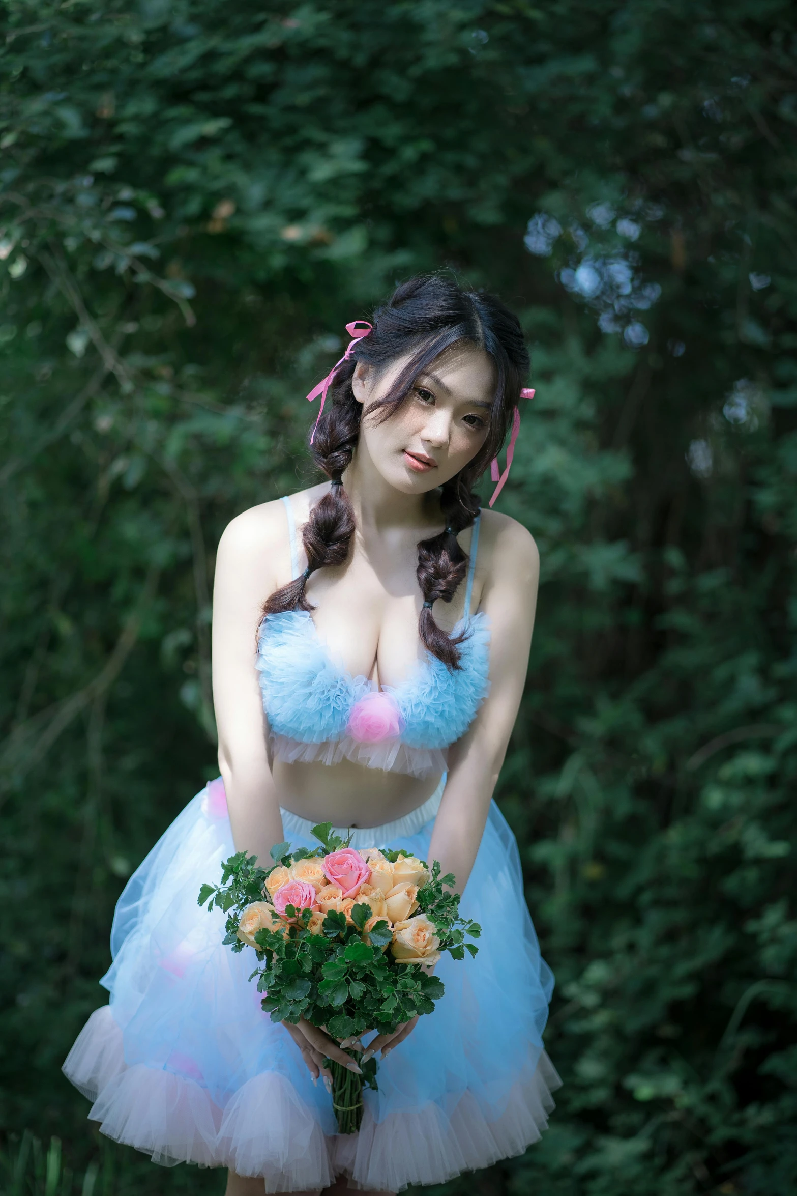 a woman in a blue tutu and headpiece poses 