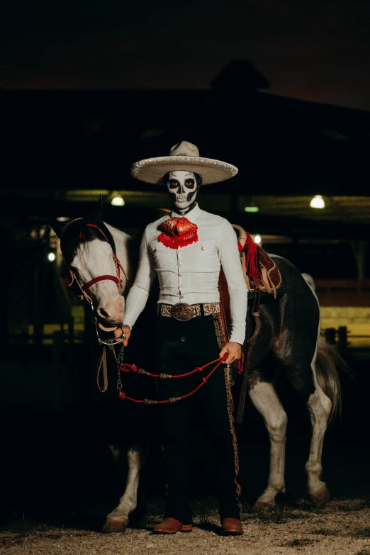 the man is posing with his horse on a leash