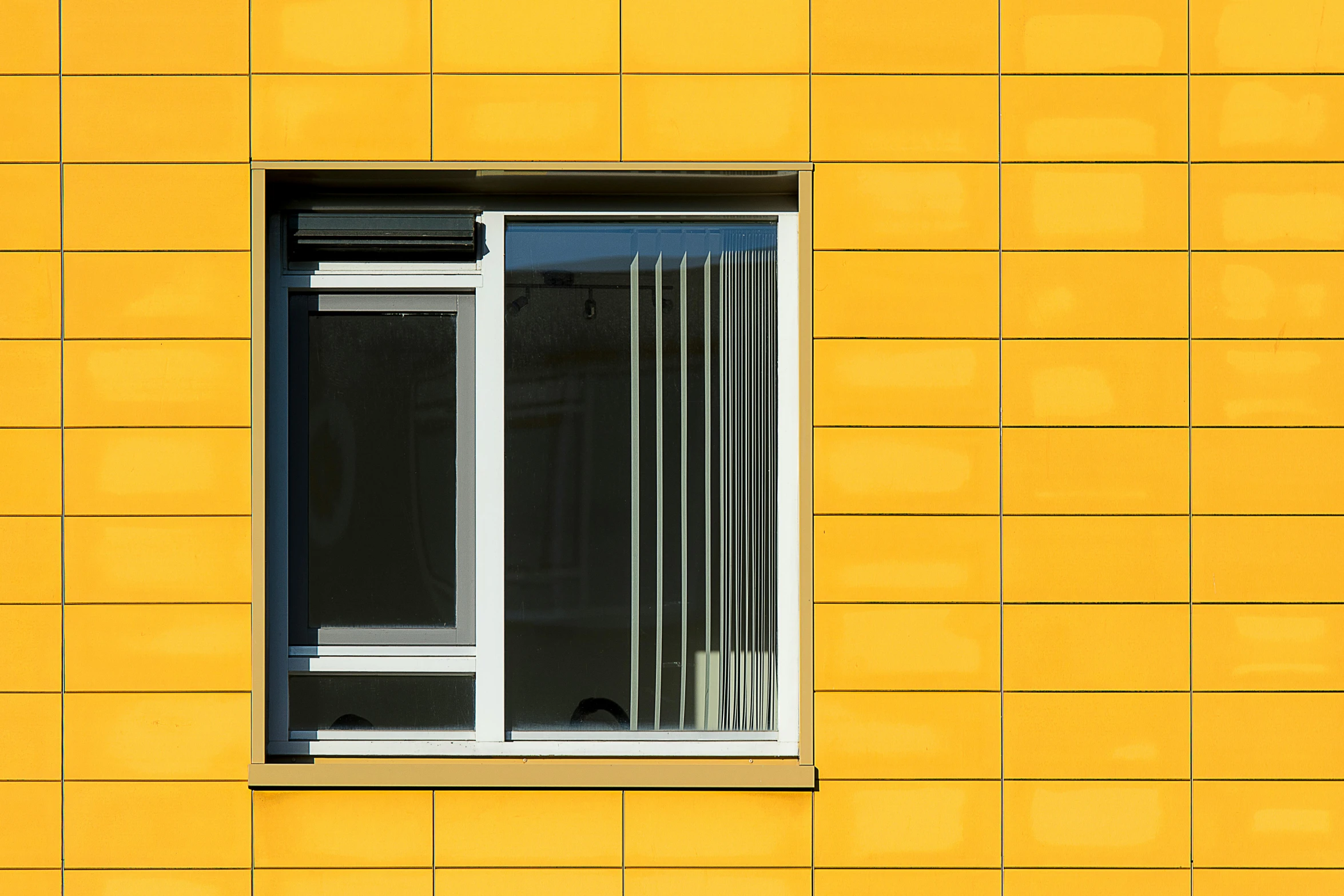 the window on the yellow wall is open