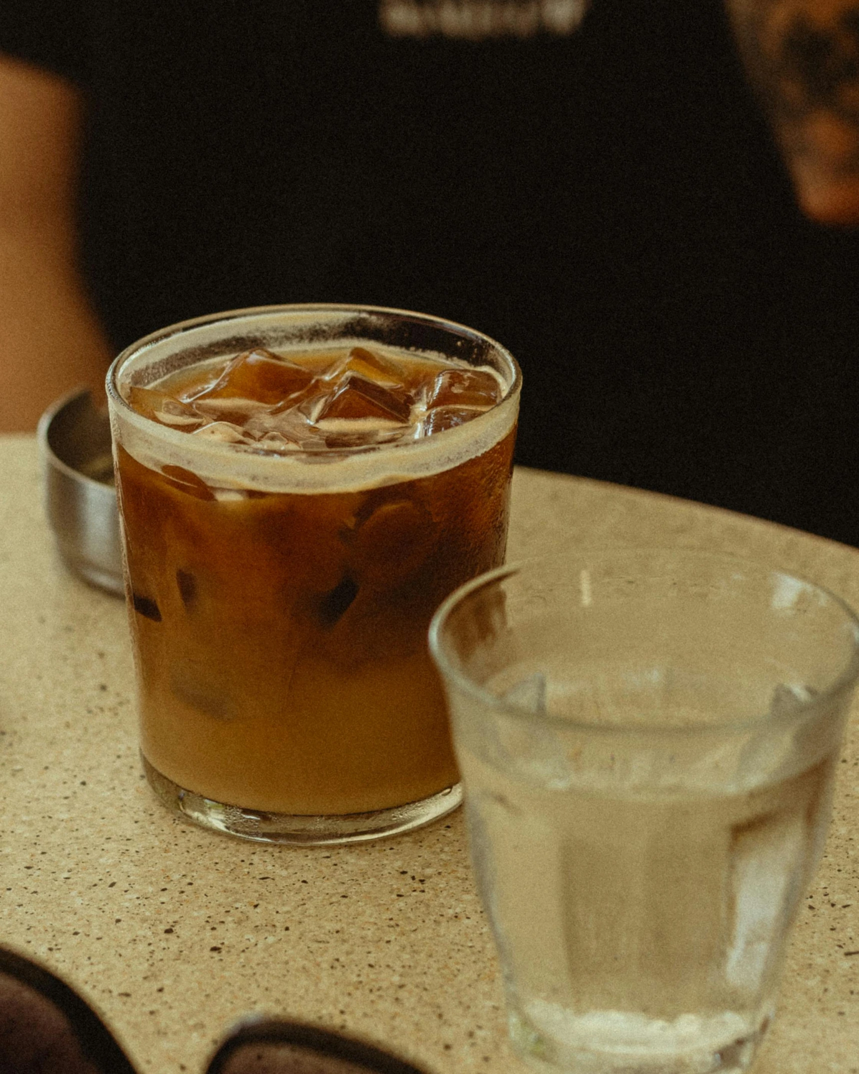 a drink on the table and sunglasses