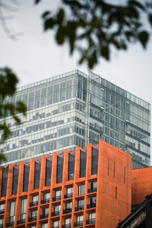 a tall building sitting next to a large glass tower