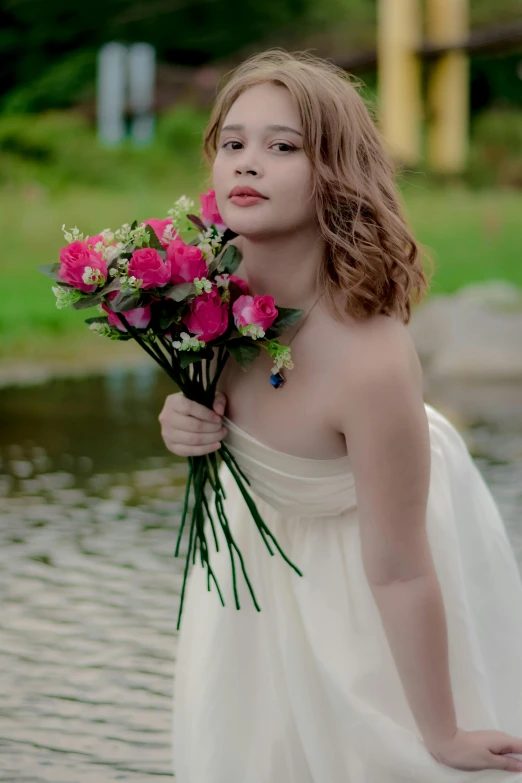 a woman is holding a bouquet of flowers in front of her face