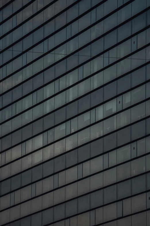 a building with windows is bricked in gray