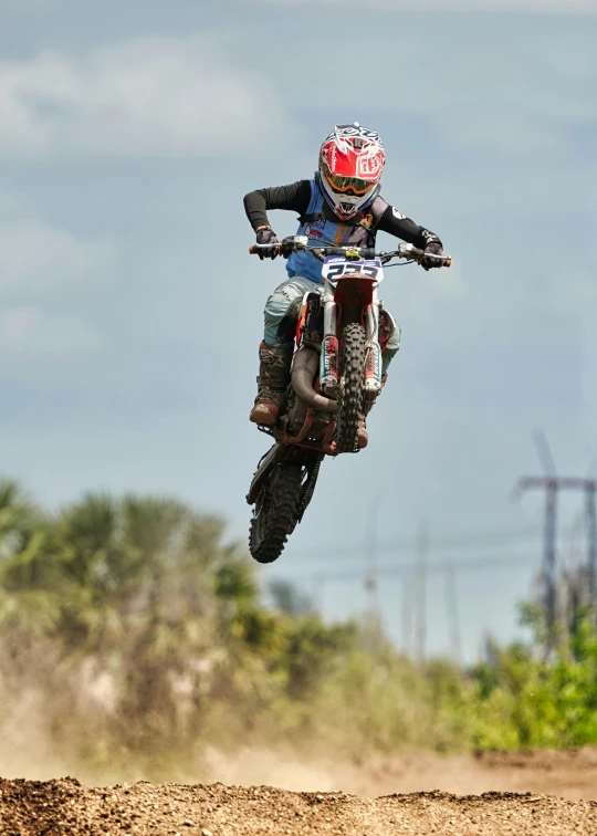 a motorcyclist riding on a dirt bike down a hill