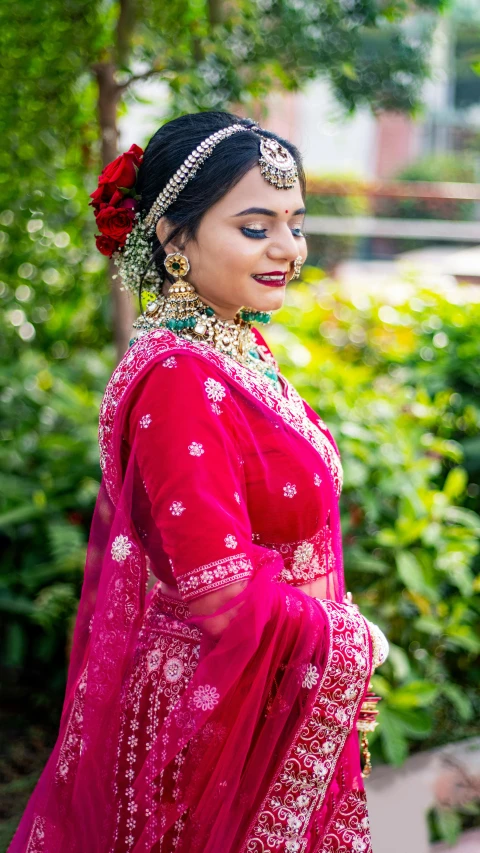 woman in a pink dress with a red rose in her hair