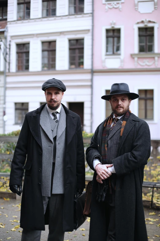 the two men are dressed in old fashioned clothes