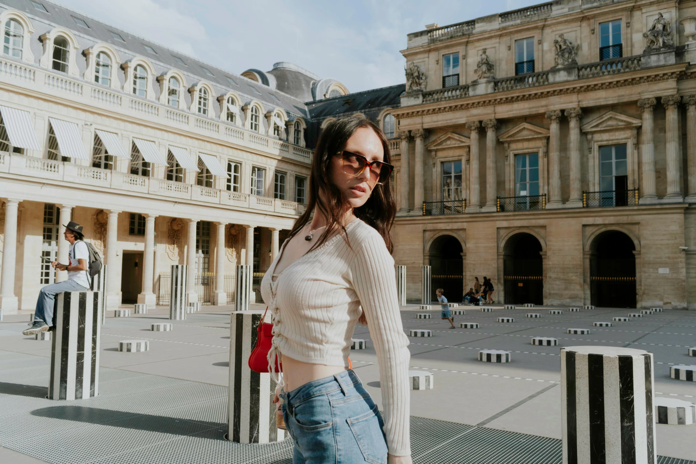 a woman standing in front of some buildings