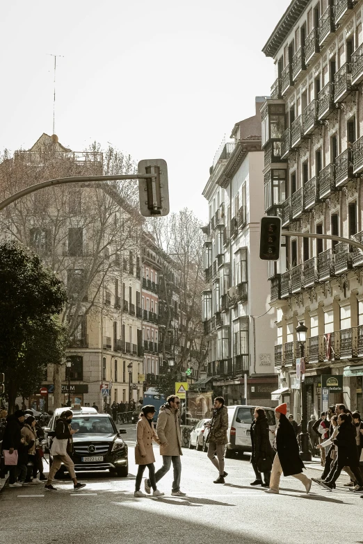 people walk through a large open city street