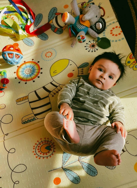 a small child laying on a patterned rug