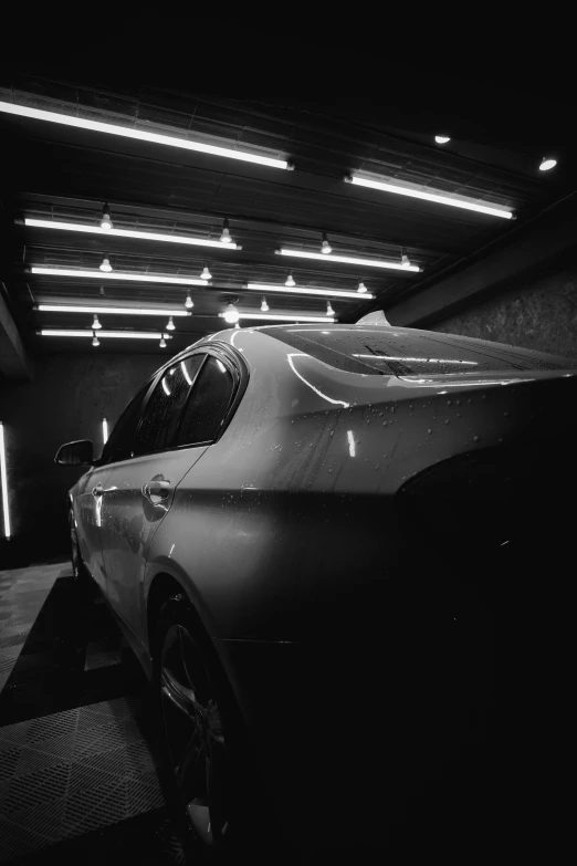 a car is parked inside a garage in a black and white image