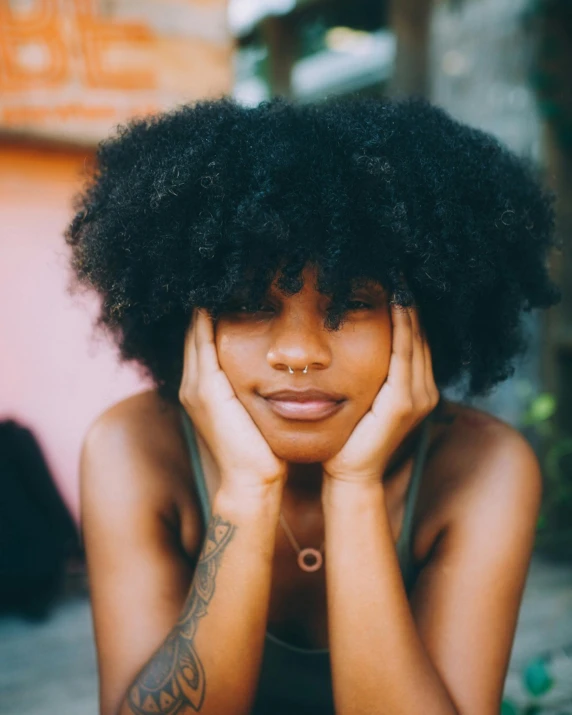 a woman is laying her head on her hand