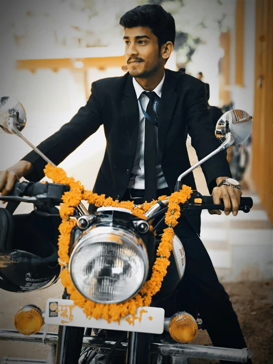 a man in a suit on a motorcycle smoking