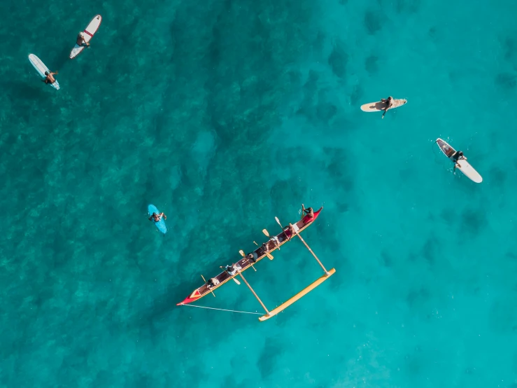 three boats with people riding on the front sailing