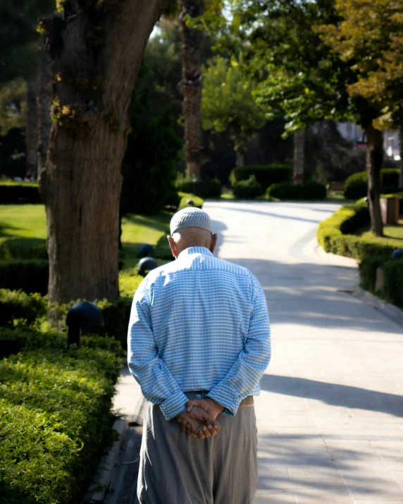 the elderly man is walking down the street