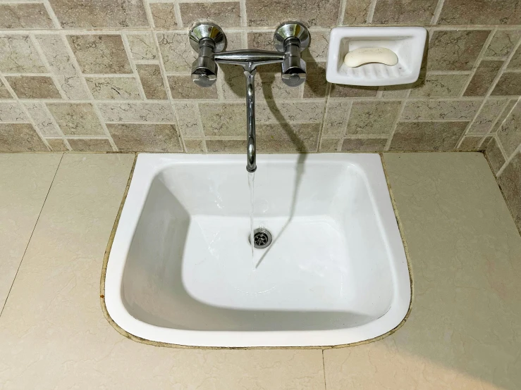 a white sink sitting in the middle of a bathroom