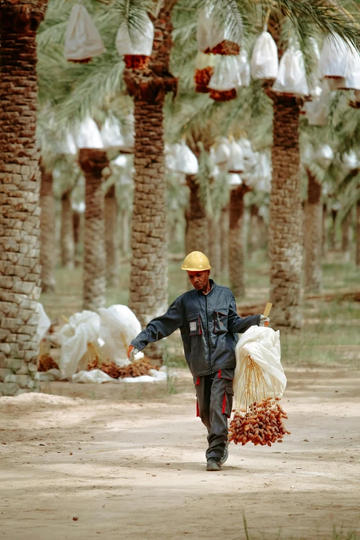 a man is walking with his belongings through the streets