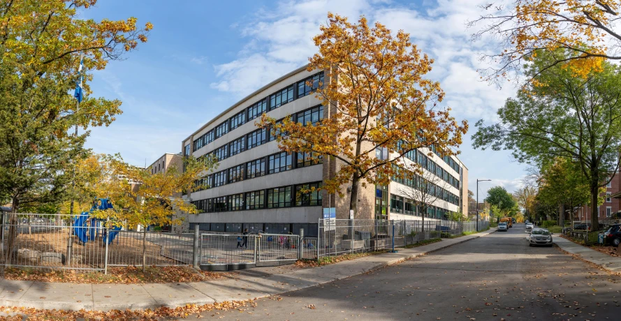 an office building sits on the corner of a city street