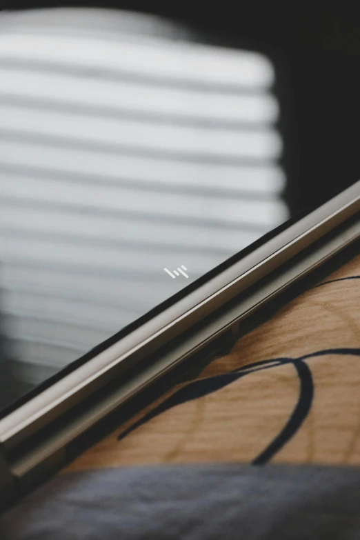 a smart phone laying on top of a wooden table