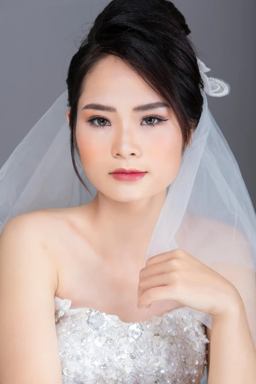 a beautiful woman posing with her veil over her head