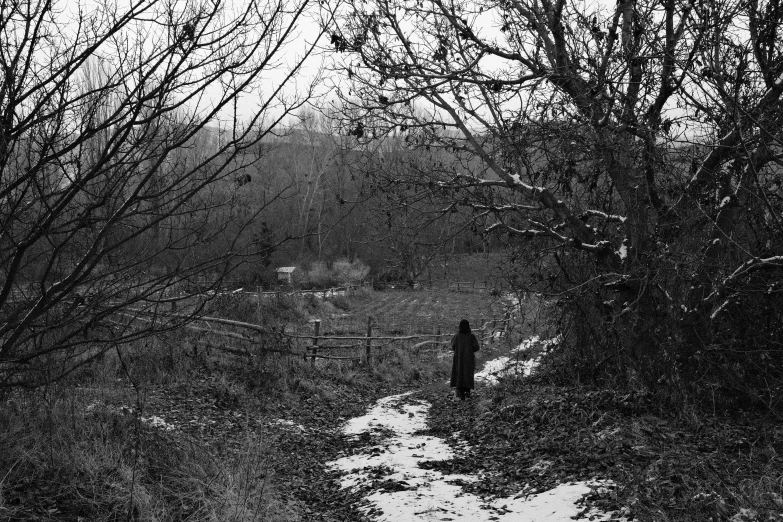 the silhouette of a person standing in a snow covered field