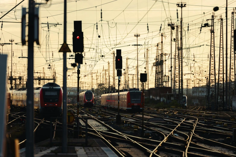 a red train on tracks next to many other train tracks