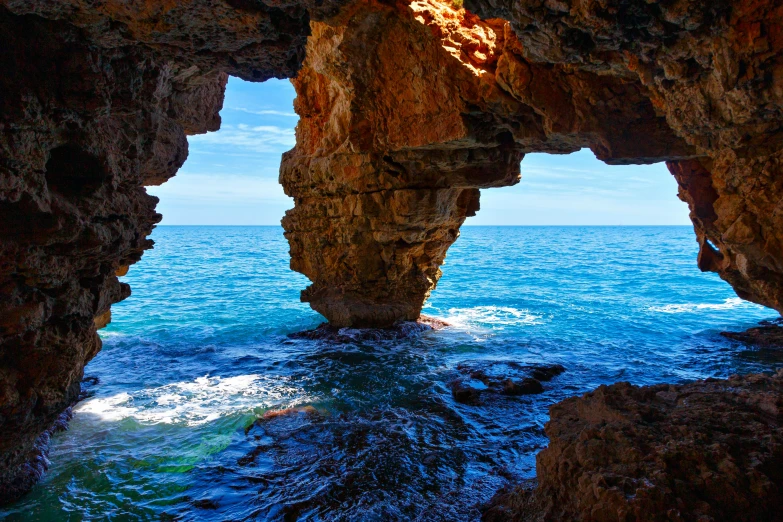 a rocky outcropping that opens into the ocean