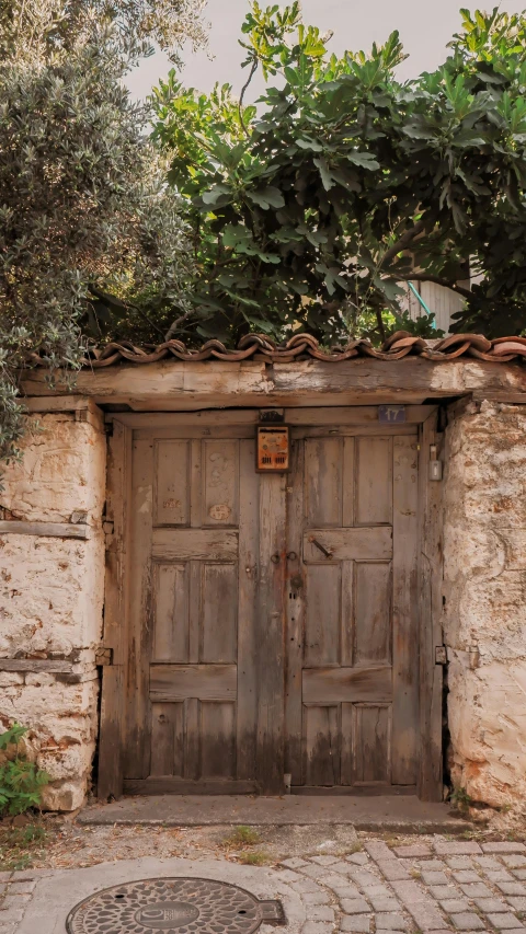 two wood doors surrounded by a brick wall