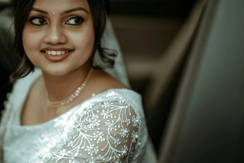 a beautiful bride is in her wedding car