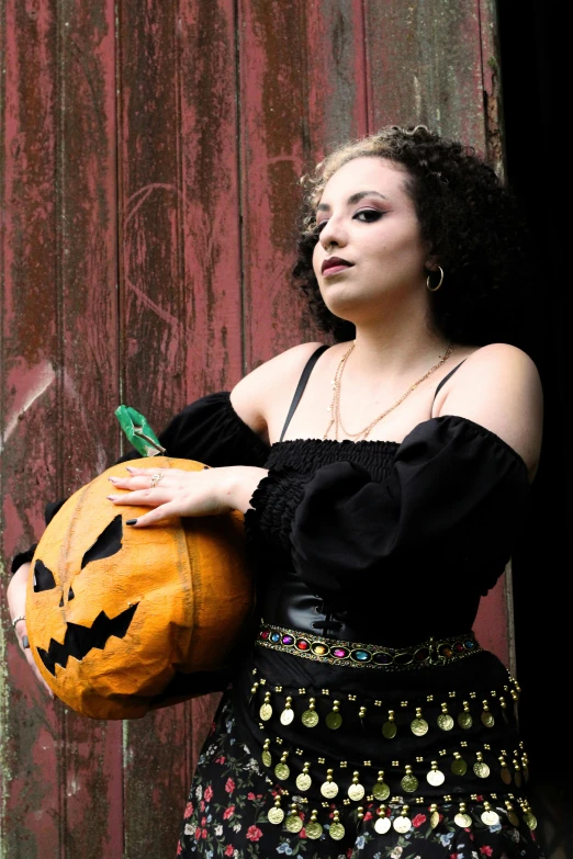 an image of a woman holding a pumpkin